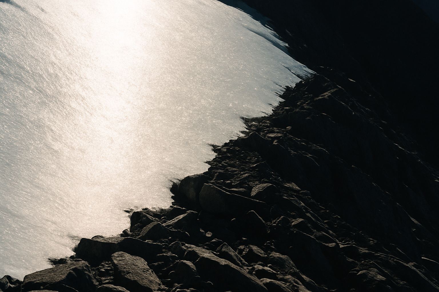 Snow and rock reflection, editorial abstract
